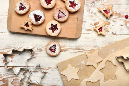 Cooking tasty Linzer cookies on white wooden background