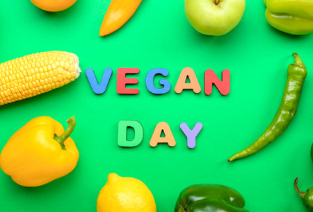 Text VEGAN DAY, different vegetables and fruits on green background, closeupの写真素材