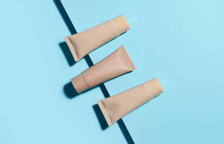 Different makeup foundation on blue backgroundの写真素材