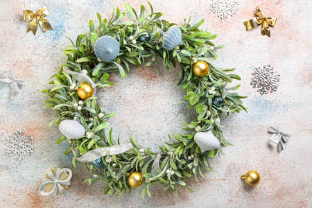 Beautiful mistletoe wreath on grunge background