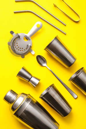 Different cocktail utensils on yellow background, closeupの写真素材