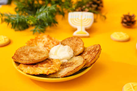 Latkes for Hanukkah celebration on color backgroundの写真素材