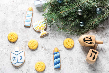 Cookies for Hanukkah celebration with dreidels and Christmas decor on grunge backgroundの写真素材