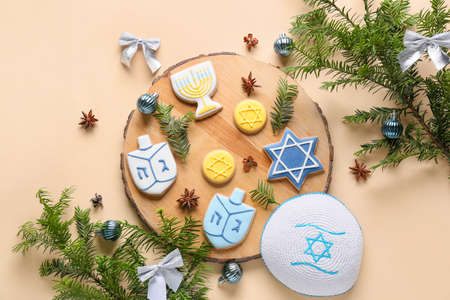 Cookies for Hanukkah celebration with Jewish hat and Christmas decor on light backgroundの写真素材