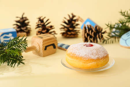 Sufganiyah for Hanukkah celebration with Christmas decor on color backgroundの写真素材