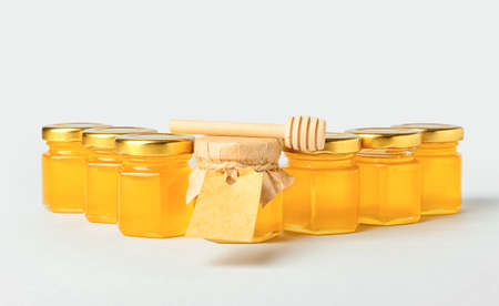 Jars with honey on light backgroundの写真素材