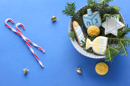 Cookies for Hanukkah celebration and Christmas decor on color backgroundの写真素材
