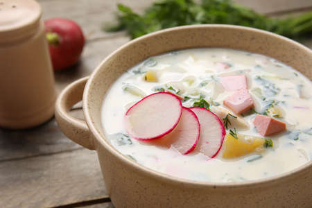 Bowl of delicious okroshka on wooden background, closeupの写真素材