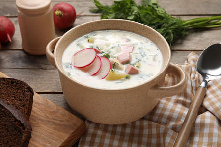 Bowl of delicious okroshka on wooden backgroundの写真素材