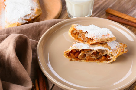 Plate with pieces of tasty pumpkin strudel on table, closeupの写真素材
