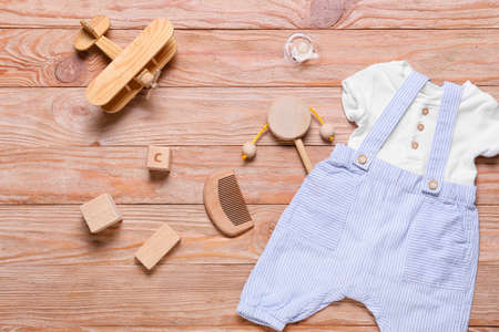 Baby boy clothes and accessories on wooden background