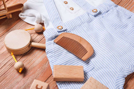 Baby boy clothes and accessories on wooden background, closeupの写真素材