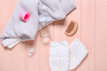 Baby clothes and accessories on pink wooden backgroundの写真素材