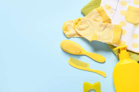 Baby clothes and different bath accessories on blue background, closeupの写真素材