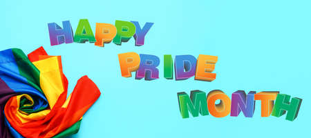 Rainbow LGBT flag and text HAPPY PRIDE MONTH on light blue backgroundの写真素材