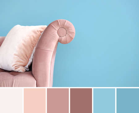 Stylish comfortable sofa near light blue wall. different color patternsの写真素材