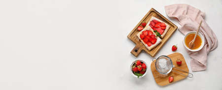 Composition with sweet strawberry puff pastries on light background with space for textの写真素材