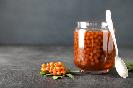 Jar with delicious rowan jam on dark backgroundの写真素材