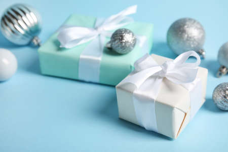 Gift boxes and Christmas balls on blue background, closeupの写真素材