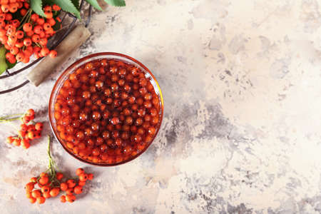 Glass bowl with tasty rowan jam on grunge backgroundの写真素材