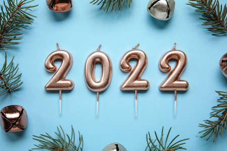 Winter composition with fir branches and figure 2022 on blue background, closeupの写真素材