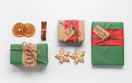 Christmas composition with gift boxes and tasty cookies on white background