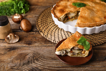 Plate with piece of tasty chicken pot pie on wooden backgroundの写真素材