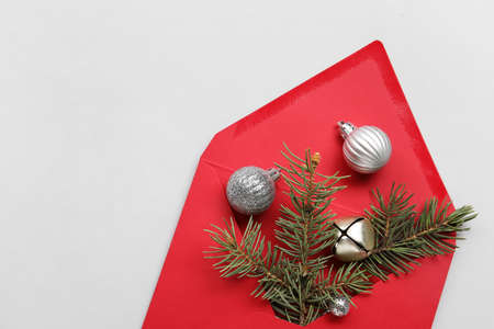 Envelope with fir tree branch and balls on light background, closeupの写真素材