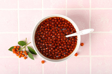 Bowl with healthy rowan berry jam on table