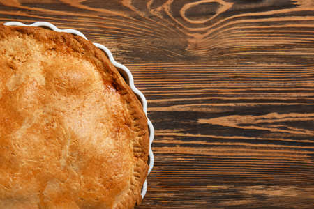 Baking dish with tasty chicken pot pie on wooden background, closeupの写真素材