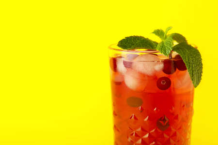 Glass with tasty cranberry juice on color backgroundの写真素材