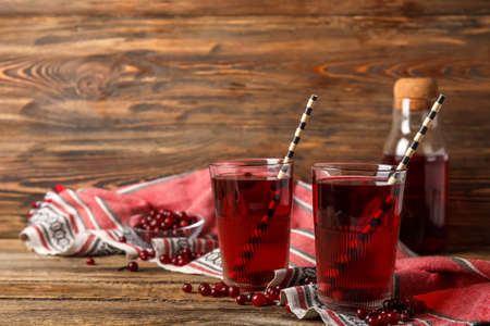 Glasses with healthy cranberry juice on wooden backgroundの写真素材