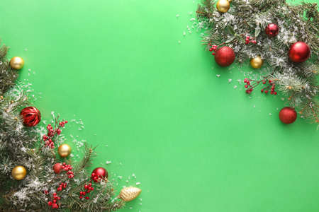 Christmas composition with fir branches and decorations on green background, closeupの写真素材