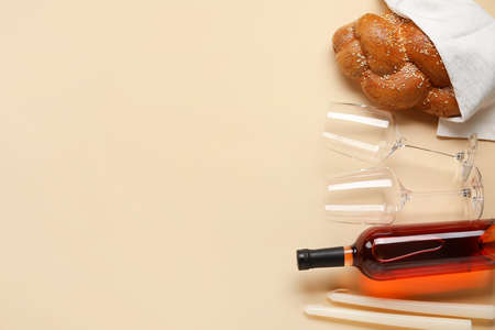Traditional challah bread with wine and candles on light background. Shabbat Shalom