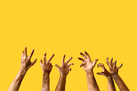 Hands of zombies on color backgroundの写真素材