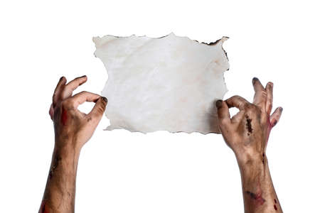 Hands of zombie with empty paper sheet on white backgroundの写真素材