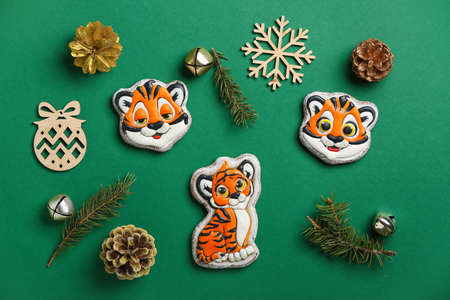 Cute cookies in shape of tiger and New Year decor on color backgroundの写真素材