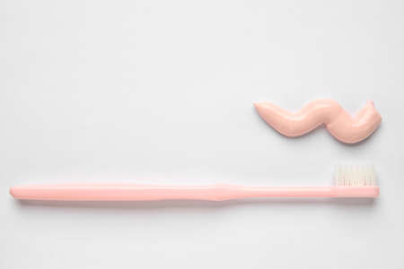 Sample of toothpaste and brush on light backgroundの写真素材