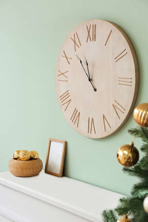 Clock hanging on wall in room. christmas countdown conceptの写真素材