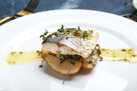 Plate of delicious sea bass fish on table, closeupの写真素材