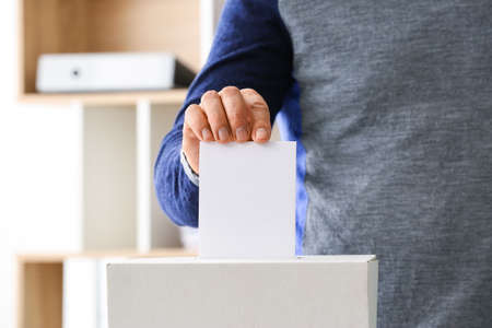Man voting at polling stationの写真素材