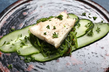 Plate of delicious sea bass fish on table, closeupの写真素材