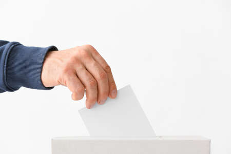 Voting man near ballot box on white backgroundの写真素材