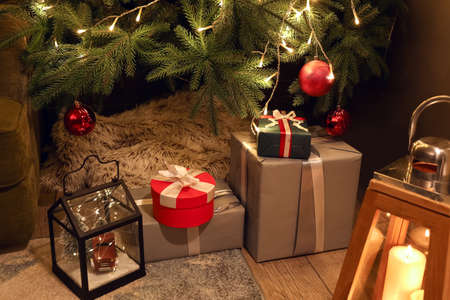 Many gifts under Christmas tree on floor