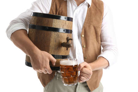 Young man with beer and barrel on white background. Octoberfest celebration