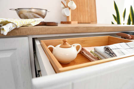 Closeup view of opened drawer with utensils in kitchenの写真素材
