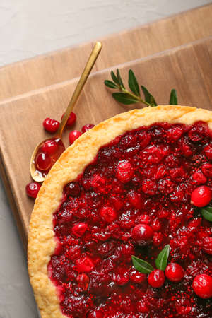 Boards with tasty lingonberry pie on table