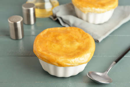 Tasty vegetable pot pies on blue wooden background