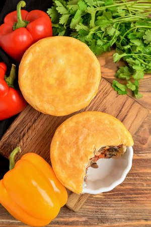 Tasty vegetable pot pies and ingredients on wooden backgroundの写真素材
