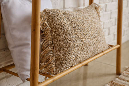 Soft pillow on shelf in roomの写真素材